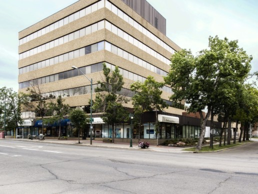 The Westcor Building sits on the corner in Edmonton - exterior outdoor view. Trees line the edges of the property, available as office space for lease.