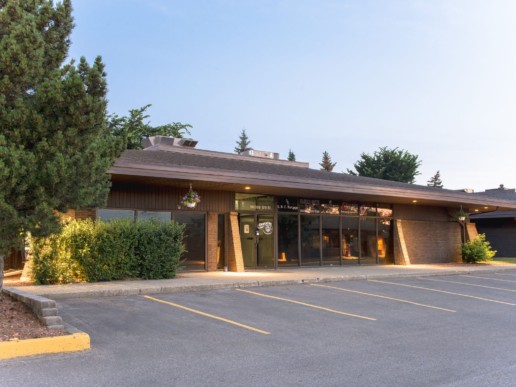 Located in Alberta, Edmonton, the entrance to the Westgate Business centre building opens up to a parking lot.